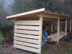 a small wooden shelter sitting in the woods