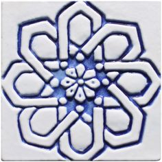 a blue and white tile with an intricate design