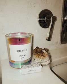 a candle sitting on top of a white counter