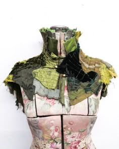 a mannequin is covered with fabric and flowers