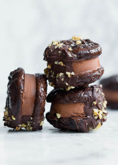 three chocolate donuts stacked on top of each other