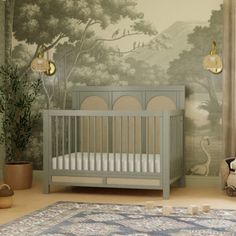 a baby's room with a crib and wallpaper