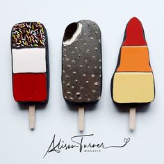 three popsicles with different colors and designs on them, one is made out of ice cream