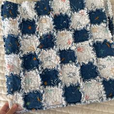 someone is holding up a quilt made from old jeans