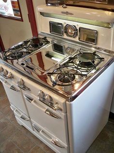 an old fashioned white stove with two burners and one oven door is sitting on the floor