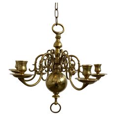 an antique brass chandelier with five candles