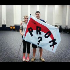 two people standing in an auditorium holding up a sign that says pro - k?