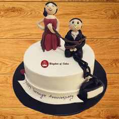 a cake decorated with an image of two people sitting on top of each other and holding hands