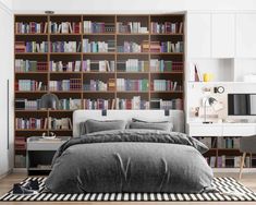 a bedroom with bookshelves and a bed in it