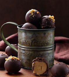 some chocolates are in a metal cup on a table