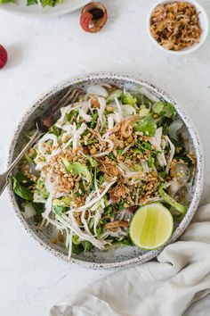 a bowl filled with salad and topped with shredded cheese