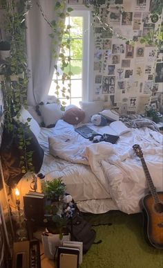 an unmade bed in a bedroom with plants growing on the wall