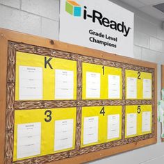 a large bulletin board in the middle of a room with yellow sticky notes on it