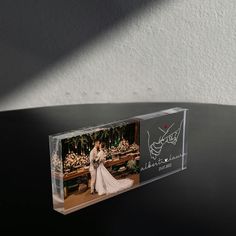 an acrylic photo frame with a bride and groom on it