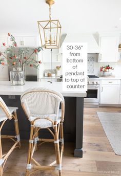 two wicker bar stools in the middle of a kitchen with white counter tops