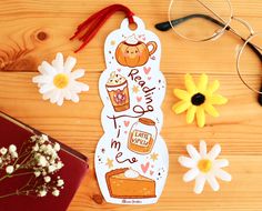 a wooden table with flowers, glasses and paper cutouts on it's side