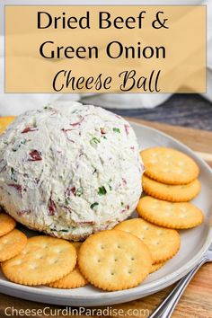 a cheese ball on top of crackers with the words, dried beef and green onion cheese ball