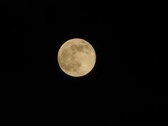 the full moon is seen in the dark sky with no clouds on it's side