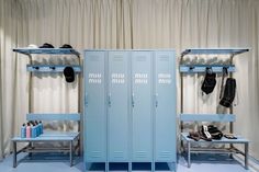 two blue lockers are next to each other in a room with white walls and curtains