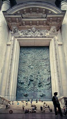 people are standing in front of a large door