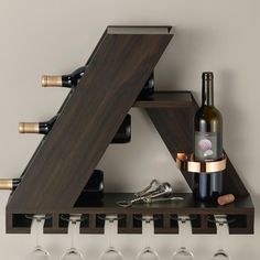 a wine rack with bottles and glasses on it