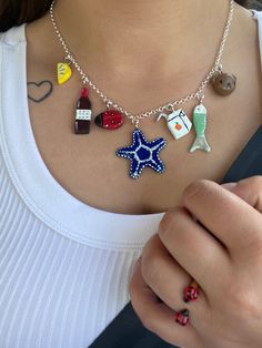 a woman wearing a necklace with charms on it