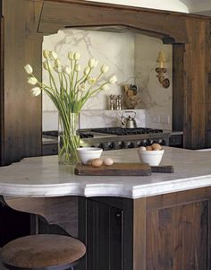 a kitchen with an island counter and stools