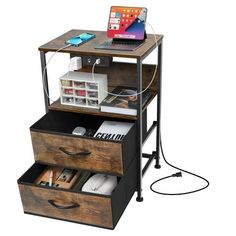 a computer desk with two drawers and a laptop on the top one drawer is open