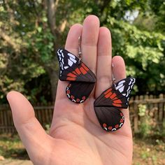 A pair of handmade monarch butterfly half wing clay earrings with brown and orange colors for an autumn aesthetic. They are made from sculpey premo polymer clay so they are durable and completely handmade by me! :) *Colors appear slightly different in person than on the screen*      Since these earrings are handmade, there may be slight imperfections and differences between each piece. Thank you for your understanding! Made From:     - Premo Sculpey Clay (approx. 3.5 grams per earring)     - 925 Sterling Silver Hooks OR 304 Stainless Steel Hooks     - Length (approx. 2.5 inches) Care Instructions:      Please refrain from dropping, or placing heavy items on top of earrings - Sculpey premo polymer clay is sturdy, but still breakable.      Do not wear in water, and store at room temperature Red Admiral Butterfly, Admiral Butterfly, Sculpey Clay, Wing Earrings, Autumn Aesthetic, Monarch Butterfly, Orange Brown, Bright Orange, Polymer Clay Earrings