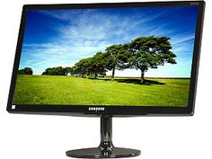 a computer monitor with trees on the screen and blue sky in the backround