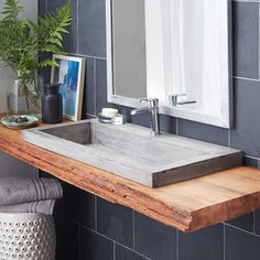 a bathroom sink sitting on top of a wooden counter