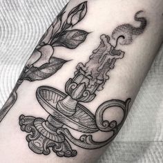 a black and white tattoo design on the arm