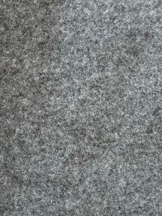 a close up view of the surface of a gray carpet