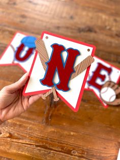 someone is holding up some paper cutouts to spell out the letter n in red, white and blue