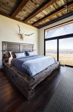 a large bed sitting inside of a bedroom on top of a hard wood floor