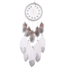 a white and brown dream catcher hanging from the ceiling with beads on it's sides