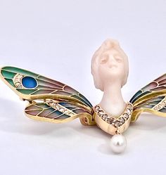 This piece is wonderful a plique a jour Butterfly with a carved Chalcedony Ladies Face.  This is in the likes of Lalique, Vever, Gaillard and Fouquet which were masters of Art Nouveau Jewelry.  These firms made items similar to this listing.  This piece is not marked at all but it is remarkable.  This piece weighs 11.72 grams is 2 .25 wide and 1" long.  There are small Diamonds through the wings and Diamonds on the bottom of the bust and a Pearl.  The head or face of this piece is exquisitely ca Plique A Jour, Nouveau Jewelry, January 2025, Art Nouveau Jewelry, Art Masters, The Wings, Woman Face, Lalique, Art Nouveau