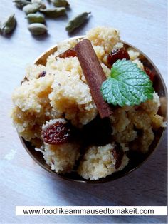 a small bowl filled with food on top of a wooden table next to nuts and leaves