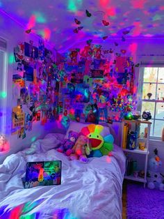 a bedroom with colorful lights on the ceiling