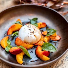 a plate that has some kind of food on it with leaves and nuts in the background