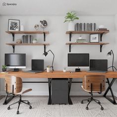 two desks with computers on them in an office