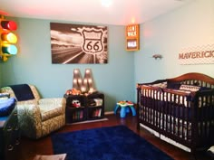 a baby's room decorated in blue and brown