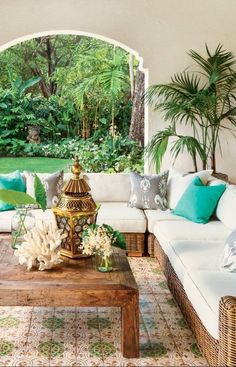 a living room filled with lots of furniture and plants