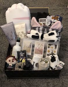 the contents of a gift box are laid out on the floor, including socks and other items