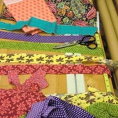 many different types of fabric are laid out on a table