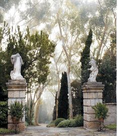 an image of a garden setting with statues