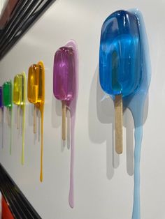 colorful popsicles are lined up on the wall