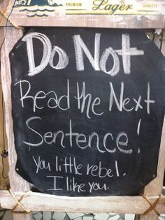 a chalkboard sign that says do not read the next sentence