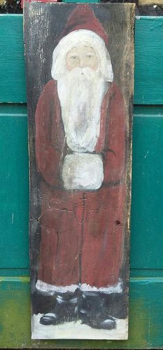 a painting of a santa clause on a green painted wooden board with black and white stripes