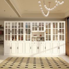 a large room with white cabinets and black and white rugs on the floor in front of it